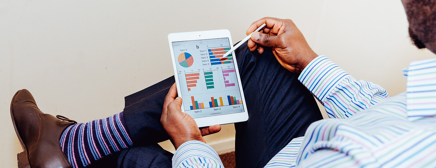 Man looking on the tablet with colorful charts