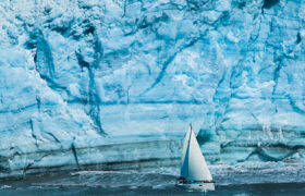 Sailing boat with a glacier in the background
