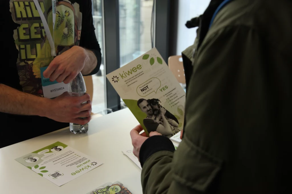 A person holding Kiwee flyer during job fairs.