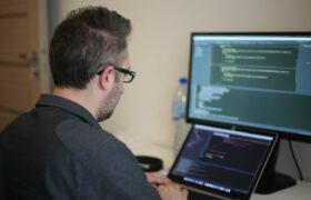 Men programming on a laptop